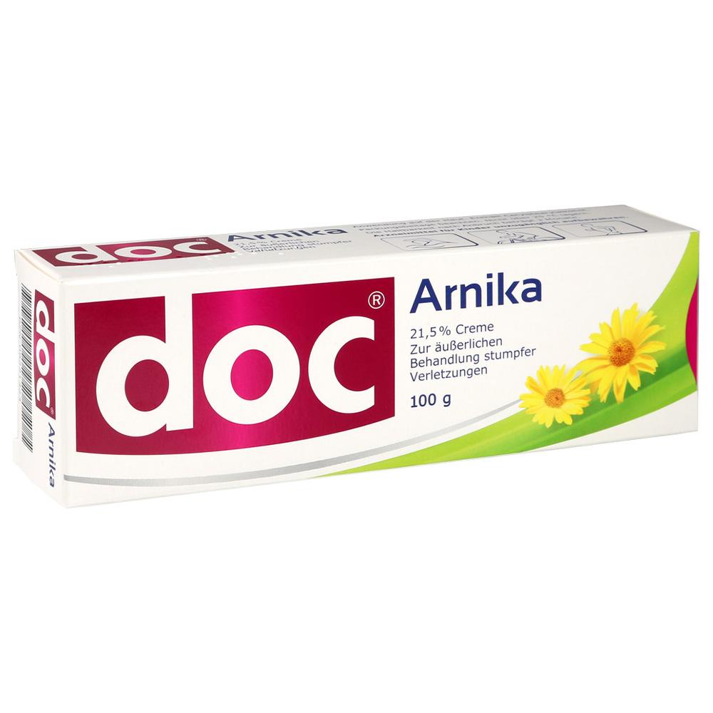 Eine Schachtel mit Arnika-Creme gegen Verletzungen zeigt gelbe Blüten.