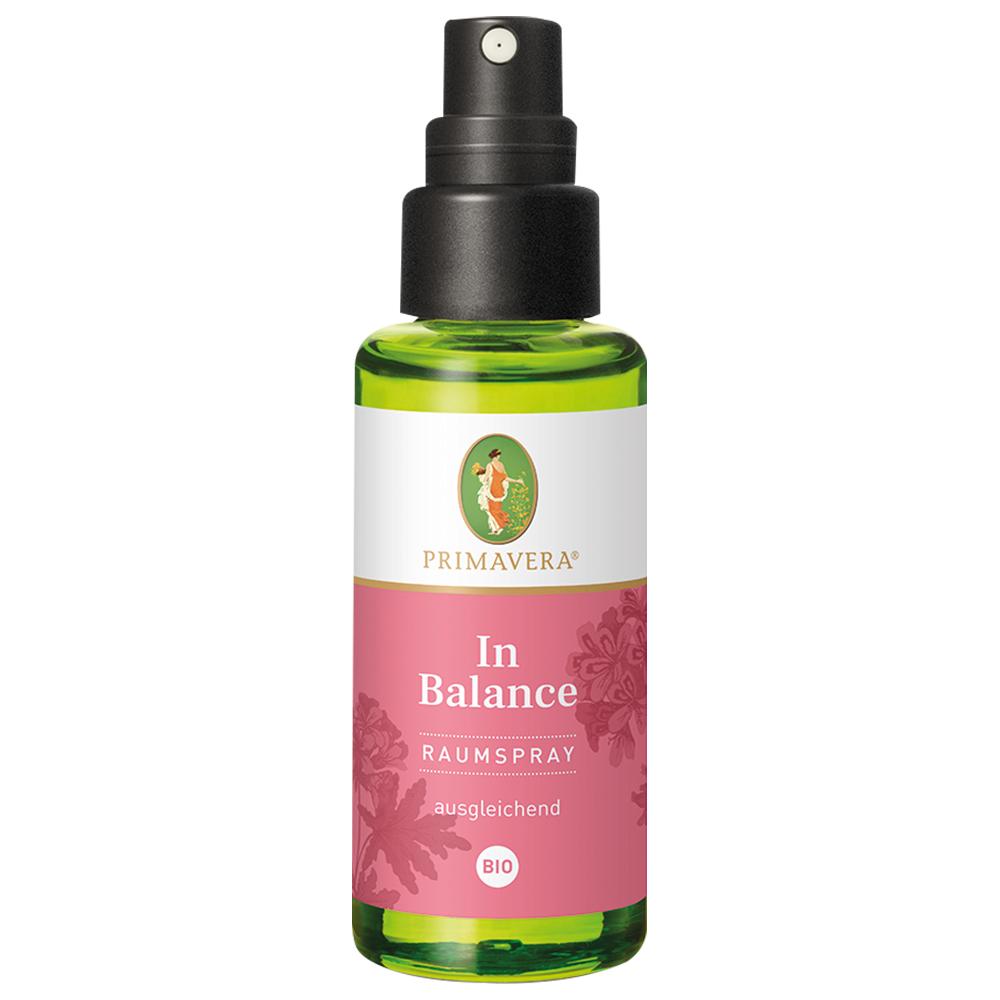 Dies ist eine grün-rosa Flasche Raumspray mit Sprühkopf.