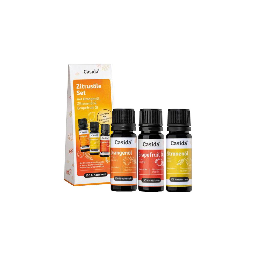 Drei Fl&auml;schchen mit Orangen-, Grapefruit- und Zitronen&ouml;l stehen neben der Verpackung.