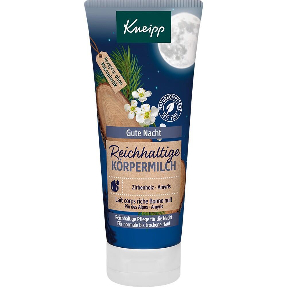 Tube mit "Gute Nacht" Körpermilch von Kneipp, vor Nachtmotiv mit Holz und Blumen.